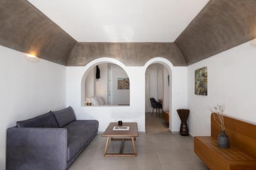 a living room with a couch and a table at Santorini Princess Spa Hotel in Imerovigli