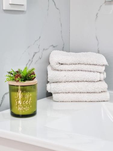 a stack of towels sitting on a shelf with a plant at Casa Caromba, Sunrise in Prazeres