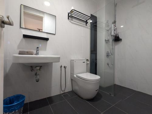 a bathroom with a toilet and a sink and a shower at Reizz Residence Majesty Suite in Kuala Lumpur