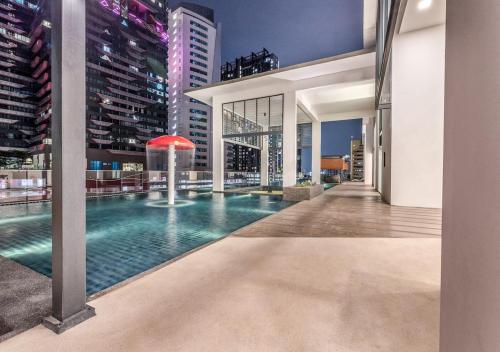 a pool in the middle of a building with tall buildings at Reizz Residence Majesty Suite in Kuala Lumpur