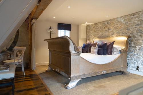 a bedroom with a bed with pillows on it at Gileston Manor-Self catering in Saint Athans