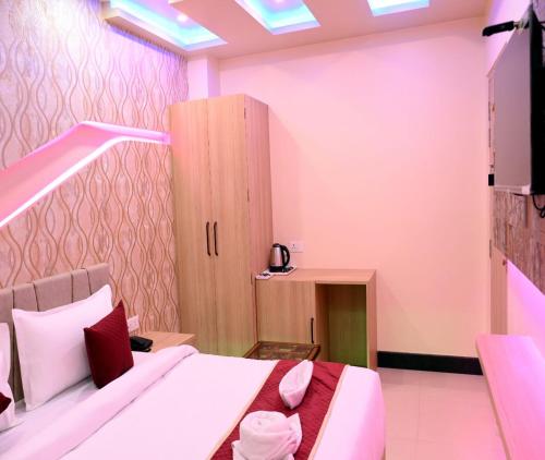 a bedroom with a bed and a cabinet in it at Hotel Shankara Residency in Varanasi