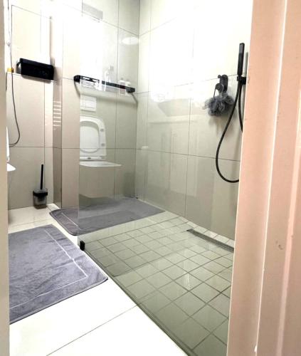 a bathroom with a shower with a glass door at ROBIES MANs CAVE in Alberton