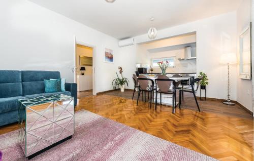 a living room with a blue couch and a table at 6 Bedroom Amazing Home In Bilice in Bilice