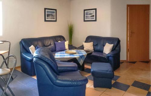a living room with two leather chairs and a table at Nice Apartment In Rubkow Ot Krenzow in Krenzow