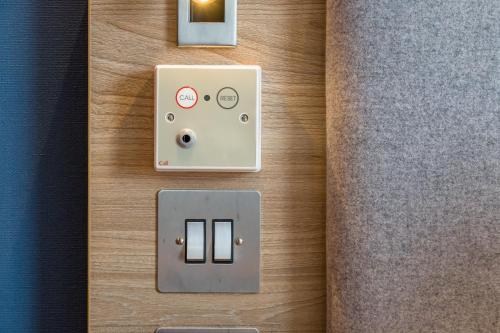 an open door with an electrical outlet on a wall at Holiday Inn Express - Bodmin - Victoria Junction by IHG in Bodmin