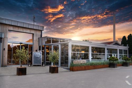 a building with a sunset in the background at Feddet Strand Resort in Faxe