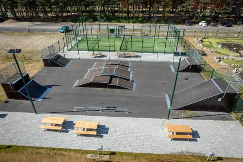 a park with benches and a tennis court at Feddet Strand Resort in Faxe