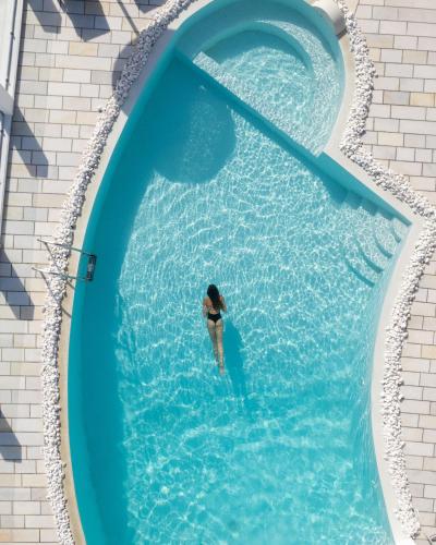an overhead view of a person in a swimming pool at Santorini Princess Spa Hotel in Imerovigli