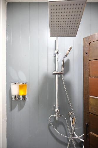 a shower with a shower head in a bathroom at Mata villa มาตา วิลล่า in Chiang Mai