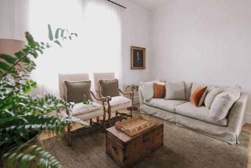 a living room with a couch and two chairs at Merchant on Malop - Luxe City Escape in Geelong