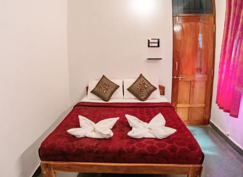 a bedroom with a bed with two white pillows at House Of Brothers in Arambol
