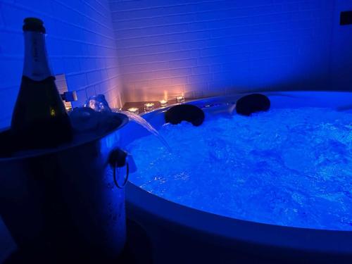 a hot tub with a bottle of beer in it at Suite lima - benamahoma in Benamahoma