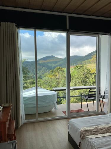 a room with a tub and a large window at The will glamping&camping in Ban Na Pho