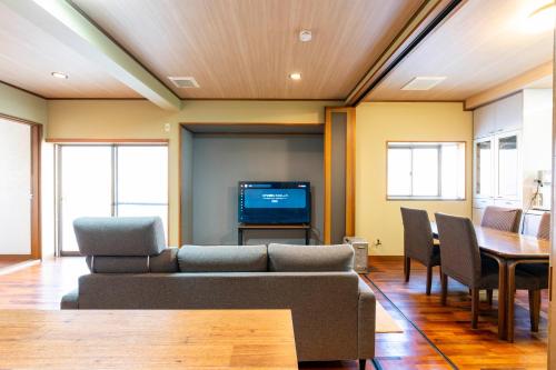 a living room with a couch and a table at SAKURA Ideal Base for Yoshino & Koyasan in Gojō