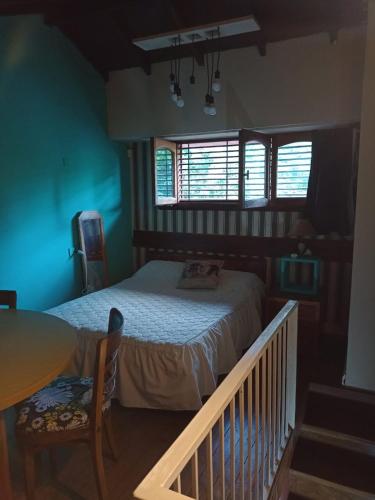 a bedroom with a bed and a table and a window at departamento de 1 ambiente planta alta in Mar del Plata