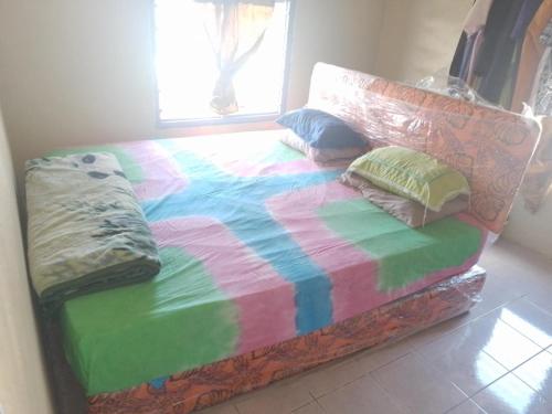 Ένα ή περισσότερα κρεβάτια σε δωμάτιο στο Manoa homestay