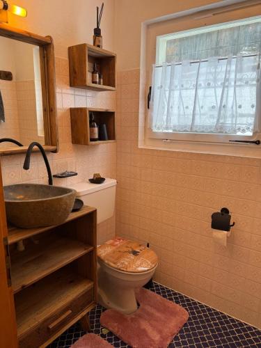 a bathroom with a sink and a toilet and a window at Berg-Bijou Scuol in Scuol