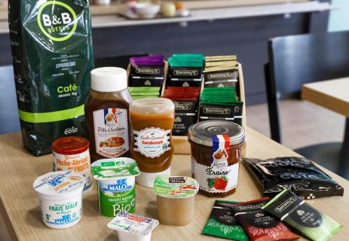 a table topped with different types of condiments at B&B HOTEL Clermont-Ferrand Gerzat in Gerzat