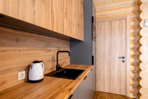 a kitchen with a counter top with a tea kettle at Готельний комплекс Парламент, Яблуниця in Yablunytsya