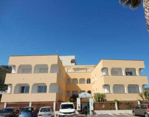 a building with cars parked in front of it at Hotel Kaly in Ventimiglia