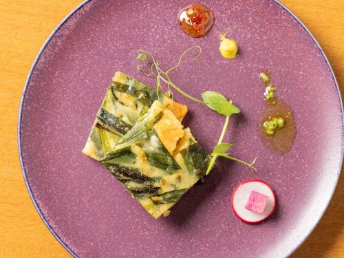 a purple plate with some food on a table at Mercure Kochi Tosa Resort & Spa in Geisei