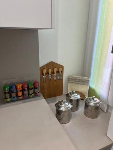 a kitchen counter with four pots and pans and a spice rack at CASA TIO PIERO Centrale accogliente e confortevole in Asti