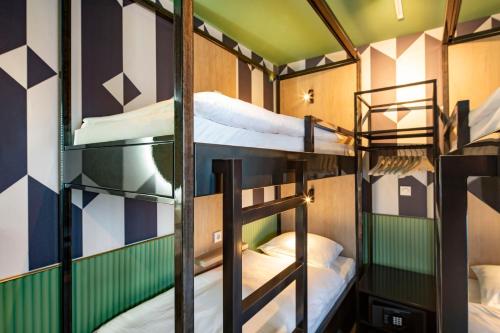 a group of bunk beds in a room at Tourist Inn Hotel Amsterdam in Amsterdam