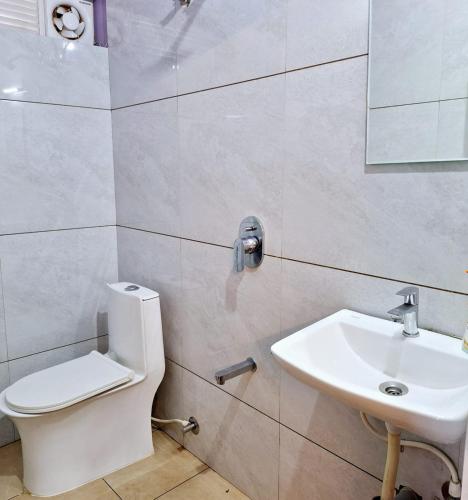 a bathroom with a toilet and a sink at Mangrove Ecostay in Gokarna