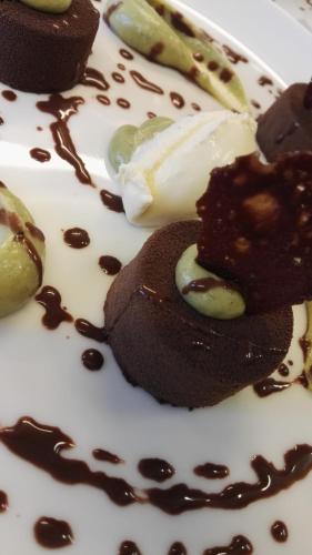 a plate with some chocolate desserts on it at Le Mascaret - Restaurant Hotel Spa - Teritoria in Blainville-sur-Mer