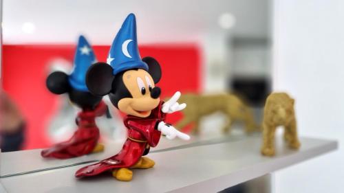 a toy figurine of mickey mouse on a shelf at Disney Luxury Studio in Serris