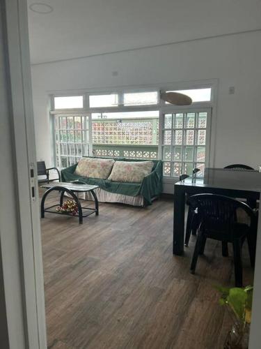a living room with a couch and a table at Casa brisa mar in Pontal do Paraná