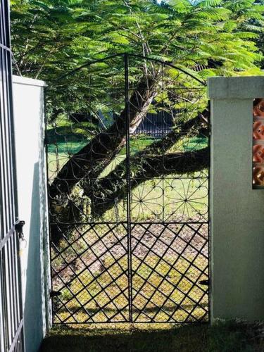 a gate with a view of a staircase behind it at Casa brisa mar in Pontal do Paraná