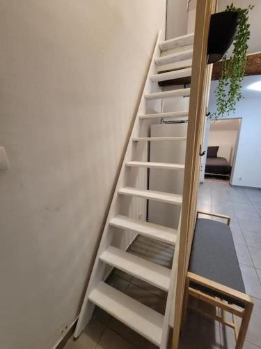 un escalier blanc à côté d'un mur blanc dans l'établissement L'Observatoire-Cité Médiévale, à Carcassonne