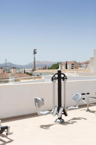 a group of chairs sitting on top of a roof at Apartamentos Martalia Áticos Deluxe in Ronda