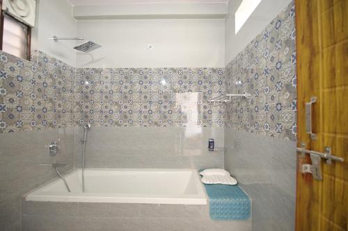 a bathroom with a bath tub and a shower at Aditya Cottage in Rishīkesh