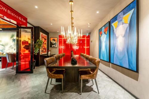 a dining room with a table and chairs at HeSu Hidden Art Hotel & Suites - Near Bell Tower & Ideal Location-Spacious rooms featuring King or Double Queen beds -Exclusive Two&Three-Bedroom Suites with Expansive Living Rooms for Group Gathering-Kitty Cuddles & Coffee Gift -Seamless Journey Planning in Xi'an