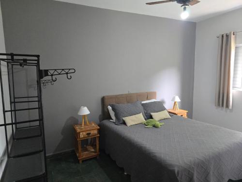 a bedroom with a bed with a green stuffed animal on it at Sitio - Mini Fazenda em ITU - SP in Itu