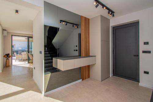 a living room with a staircase and a glass wall at Villa Bella near Rovinj and Pula in Bale