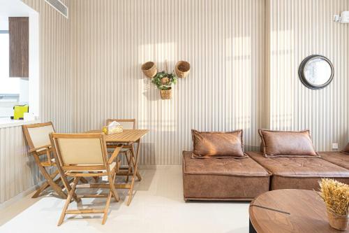 a living room with a couch and a table at 1BR Apartment - Luxury, Spacious and balcony at Al Zahia in Sharjah