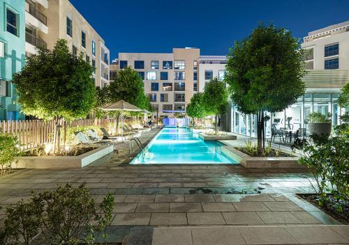 a swimming pool in the middle of a building at 1BR Apartment - Luxury, Spacious and balcony at Al Zahia in Sharjah