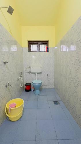 a bathroom with a blue toilet and a window at Golden pearl private villa with pool in Vythiri