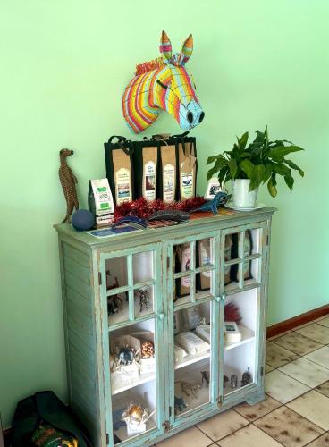 a cabinet with a horse head on top of it at Whistlewood Guesthouse Walmer, Port Eizabeth in Port Elizabeth