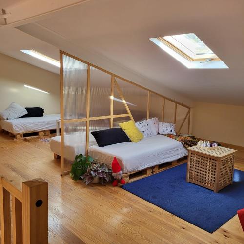 a bedroom with two beds and a skylight at Puerto de la Serrana in Jerte