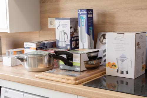 a kitchen counter with boxes and appliances on it at Apartamentos Martalia Áticos Deluxe in Ronda