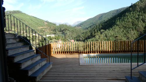 a staircase leading to a pool with mountains in the background at Varanda do Brejo in Seia