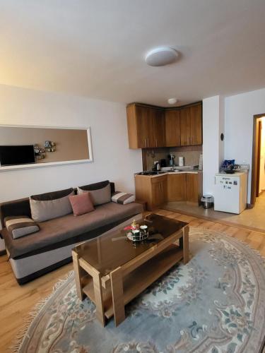 a living room with a couch and a table at Eko FIS Snowscape in Šišava