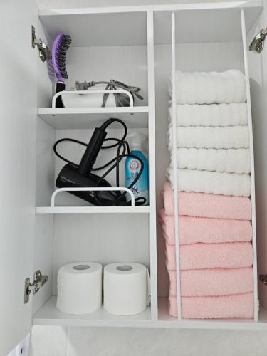 a bathroom with pink towels and a sink at Hongdae ssuny house in Seoul