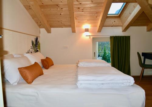 a bedroom with a large white bed with a window at Nine Rooms Double in Trento