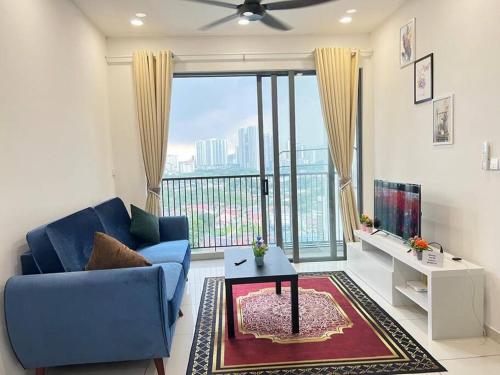 a living room with a blue couch and a large window at Cozy Kenwingston Platz KL 2-5 Pax2BR&2BR Pakin Netflix 1306 in Kuala Lumpur